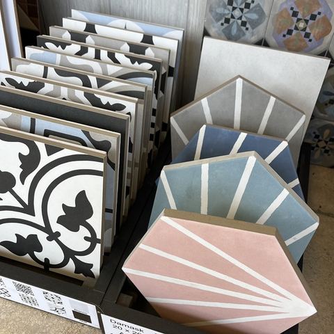 Patterned and pastel tile samples on a showroom display